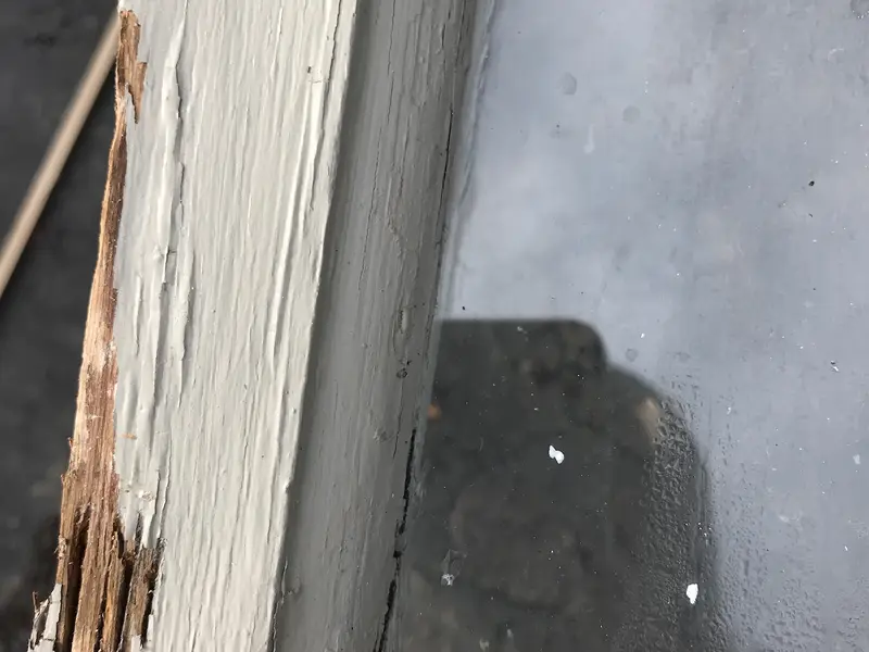 Close-up of rotted wood on the corner of a window sash