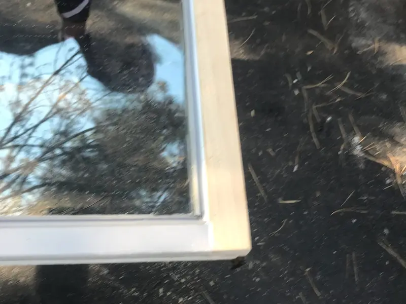 Close-up of a window sash resting on the ground
