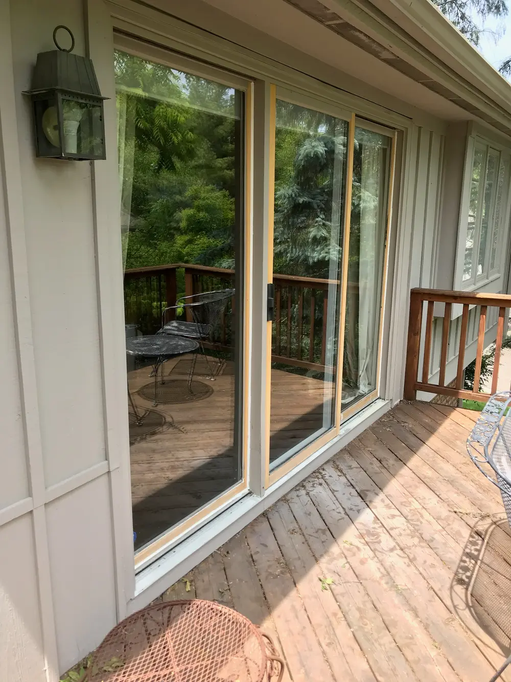 Sliding patio door opening onto a wood deck after service